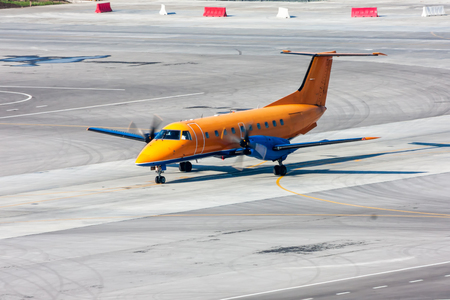 Taxiing turboprop airplane at the airport apron