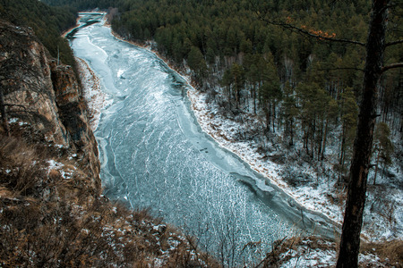 River and rocky coast in the taiga in winter