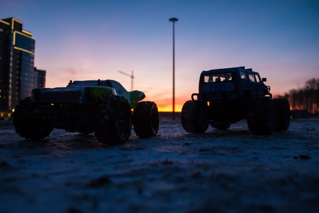 RC car monster trucks at sunset of the dayの写真素材