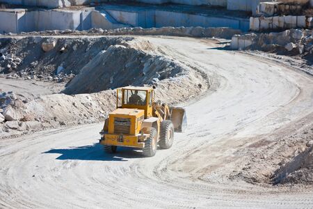 Yellow wheel tractor loader in a marble quarryの写真素材