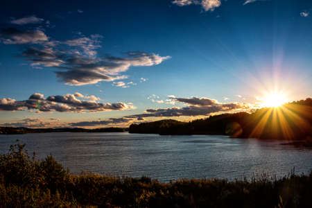 A picturesque lake in the rays of the evening sun