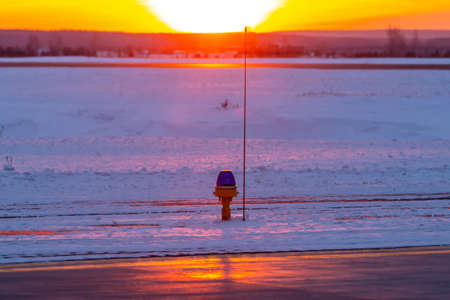 Taxiway, side row lights against the backdrop of a picturesque dawnの写真素材