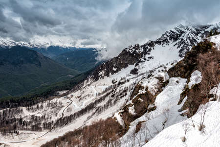 High mountain peaks covered with snow on a cloudy day
