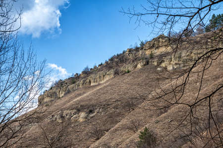 Rocky slope of a mountain range in a clear sunny day