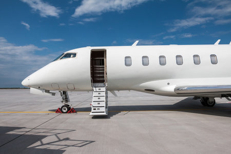Close-up of the front of the modern white private jet with an opened gangway doorの写真素材