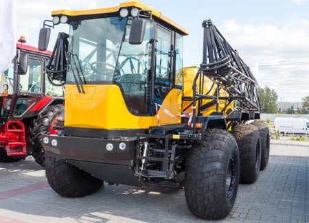Yellow agricultural all-terrain vehicle with field spraying equipmentの写真素材