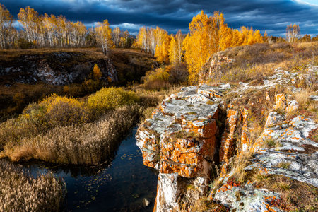 Rocky bank of a small river on an autumn dayの写真素材