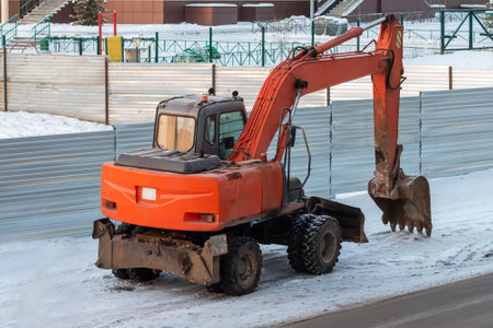 Orange wheeled excavator in the countryside in winterの写真素材