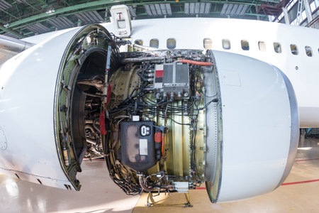 Close-up of an open high-bypass turbofan aircraft engine of a passenger airplane in a hangarの写真素材