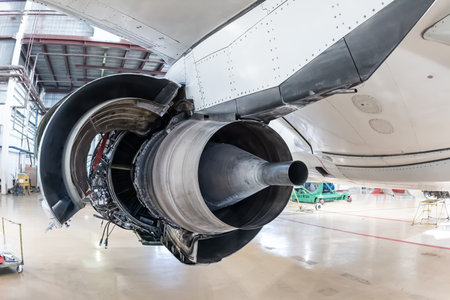 Rear view of the open high-bypass turbofan aircraft engine of a passenger jet plane in a hangarの写真素材