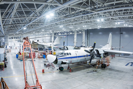 Transport aircraft in the hangar. Airplanes under maintenance. Checking mechanical systems for...