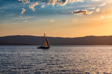 Yacht on a scenic lake in beautiful evening lightの写真素材
