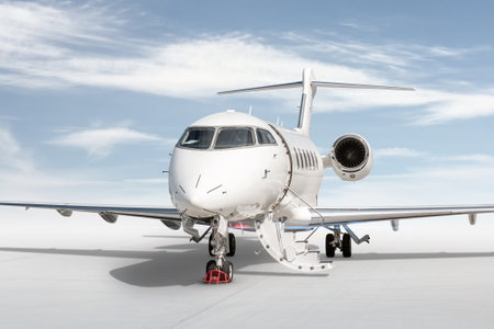 Close-up modern white business jet with an opened gangway door isolated on bright background with skyの写真素材