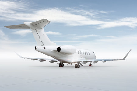 White luxury executive airliner isolated on bright background with skyの写真素材
