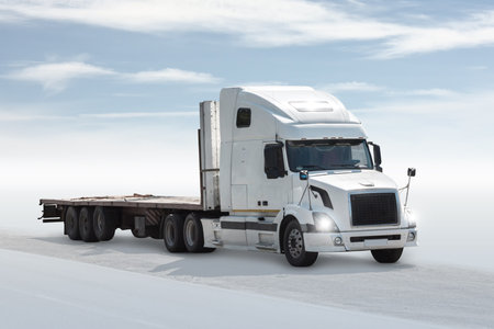 White bonnet truck with a semitrailer isolated on bright background with skyの写真素材