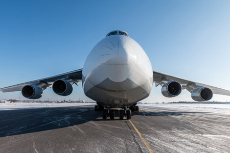 Front view of the white wide body transport cargo aircraft at winter airportの写真素材