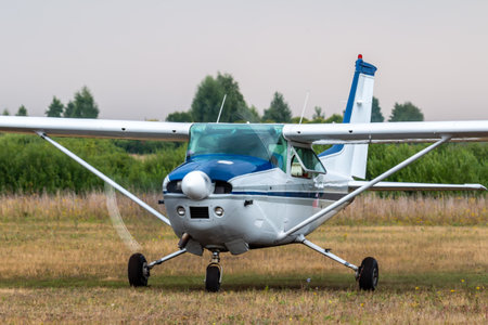 Front view of the small private aircraft with the engine running at the airfield