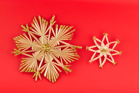 Isolated christmas decorations on red background (snow flakes, octagons)の写真素材