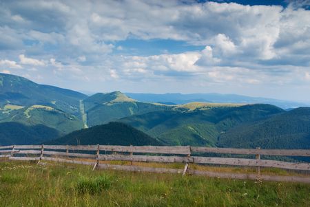 Beautiful mountain landscape with wooden fence (ideal for background or wallpaper)