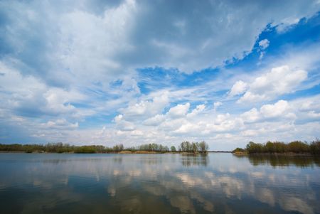 Cloudy sky and lake (can be use how background, wallpaper, texture)の写真素材