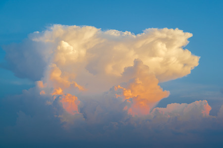 Blue sky with golden cloudsの写真素材