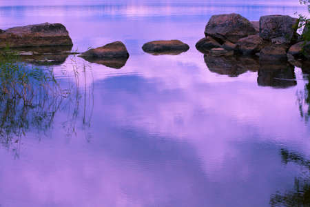lake with stones at sunsetの写真素材
