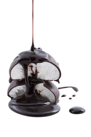 chocolate syrup being poured onto marshmallowsの写真素材