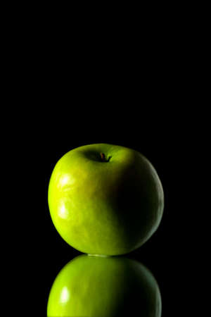 green apple isolated over black backgroundの写真素材