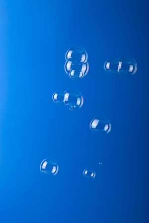 soap bubbles over blue background