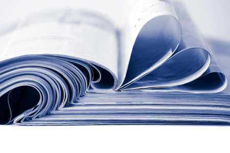 stack of magazines toned blue isolatedの写真素材
