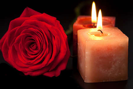 ed rose and candles over black backgroundの写真素材