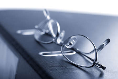 binder and glasses toned blue isolatedの写真素材