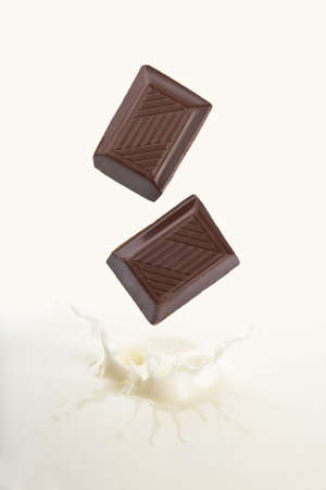 chocolate falling into milkの写真素材