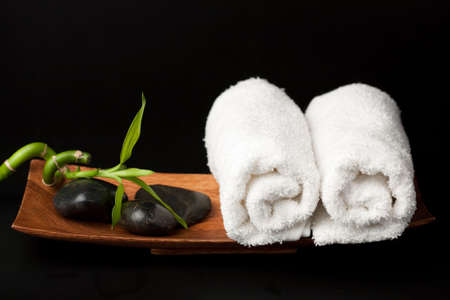 spa stones and towels over black