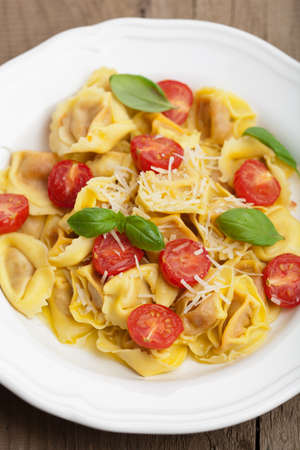 tortellini with cheese and tomatoes の写真素材