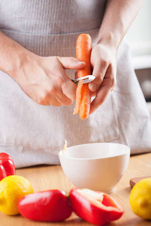 man hands peeling carrotの写真素材