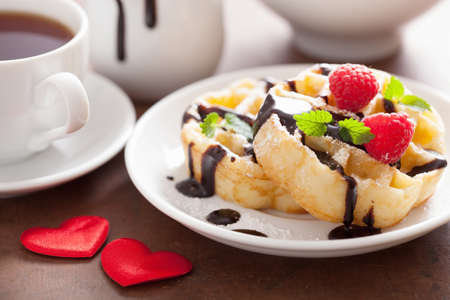 Belgian waffle with chocolate raspberry and hearts for Valentines Dayの写真素材