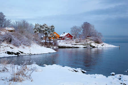 Norwegian winter fjord landscape with colorful housesの写真素材
