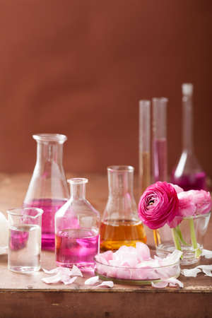 alchemy and aromatherapy set with ranunculus flowers and flasks の写真素材