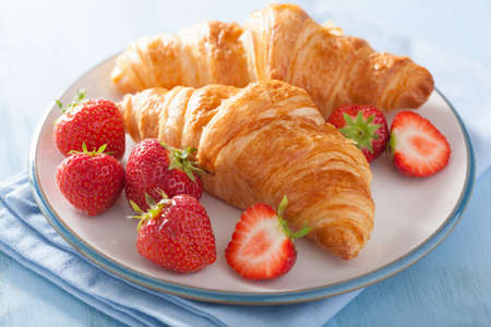 fresh croissants with strawberry for breakfast の写真素材