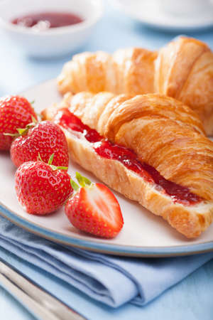 fresh croissants with jam and strawberry for breakfastの写真素材