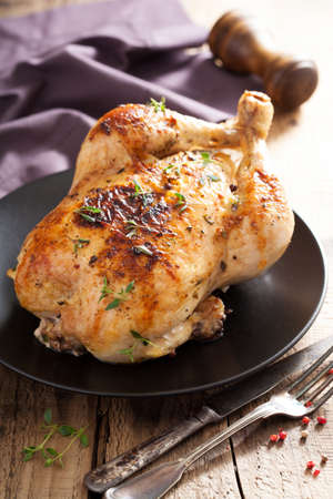whole roasted chicken with pepper and thymeの写真素材