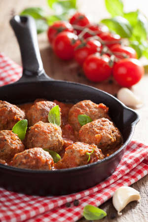 meatballs with tomato sauce in black pan の写真素材
