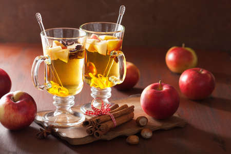 glass of mulled apple cider with  orange and spices, winter drink