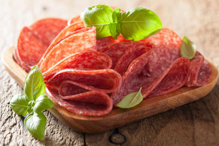 salami slices in wooden plateの写真素材