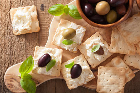 crackers with soft cheese and olives. healthy appetizerの写真素材