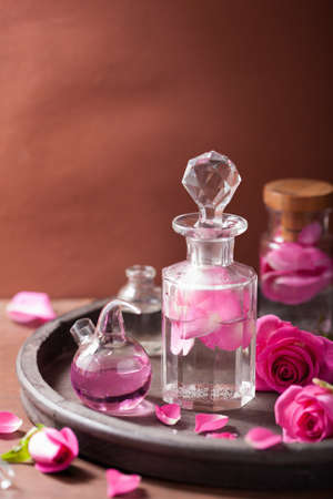 alchemy and aromatherapy set with rose flowers and flasksの写真素材