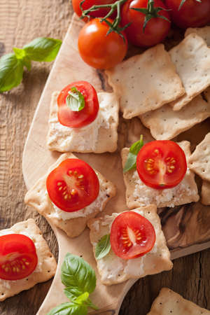 crackers with soft cheese and tomatoes. healthy appetizerの写真素材