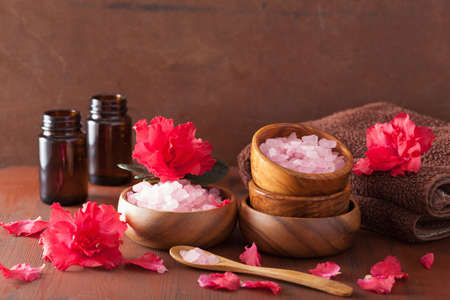spa aromatherapy with azalea flowers and herbal salt on rustic dark backgroundの写真素材