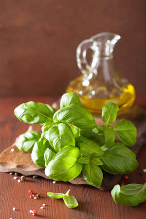 fresh basil leaves herb and olive oil on wooden backgroundの写真素材